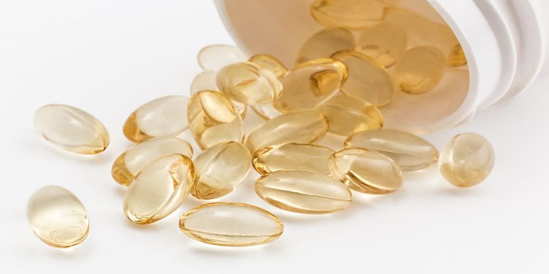 Image of an open bottle of pills with the pills rolling out.