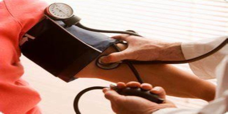 Image of a doctor taking a patient's blood pressure.